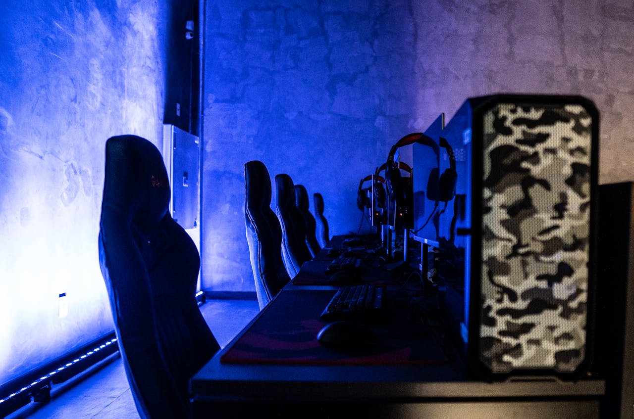 heros-img A sleek gaming room setup featuring high-performance computers and ambient blue lighting.